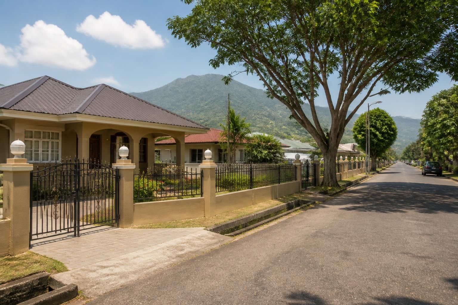 Tidy suburban street with mature trees in Marabella.